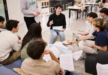 Palantir Meritocracy Fellows talking in a circle, photographed for the Wall Street Journal